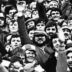 A crowd of happy Welsh fans at Cardiff Arms Park during the rugby game between Wales