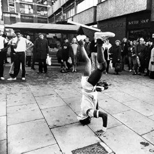 A crowd of shoppers watching a man breakdancing, Manchester. 6th February 1984