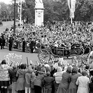 Crowd waving to the carriage of Queen Elizabeth II and Prince Philip
