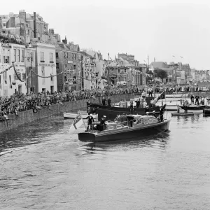 Crowds await the arrival of Her Majesty Queen Elizabeth II at St Peter Port in Guernsey Crowds await the arrival of Her Majesty Queen Elizabeth II at St Peter Port in Guernsey