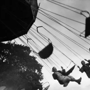 Crowds enjoying the Chair-O-Plane at the Tolworth Fun Fair in 1934