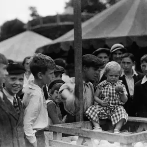 Crowds enjoying the Coconut shy at the Tolworth Fun Fair in 1934