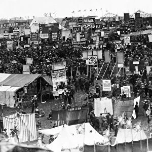 Crowds gather round bookmakers at the Epsom Derby. Circa June 1920