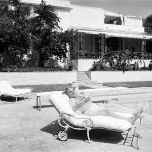 Cubby Broccoli, American film producer, pictured at his Beverley Hills home, California Cubby Broccoli, American film producer, pictured at his Beverley Hills home, California