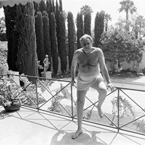 Cubby Broccoli, American film producer, pictured at his Beverley Hills home, California