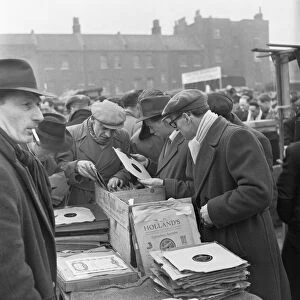 Customers at the secondhand gramophone record stall at the flea market in Club Row