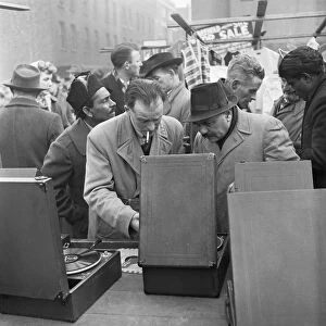 Customers at the secondhand gramophone stall at the flea market in Club Row