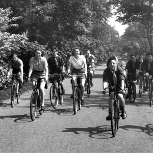 Cyclists out for a spin along a country lane near Belsay in Northumberland in 1950