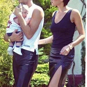 David Beckham and Victoria ("Posh Spice") with baby Brooklyn outside their home