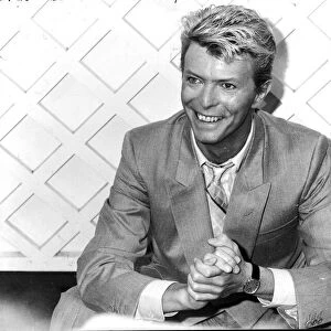 DAVID BOWIE, WEARING SUIT AND SMILING - 1983