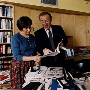 David Frost TV Presenter checking through paperwork with an assistant