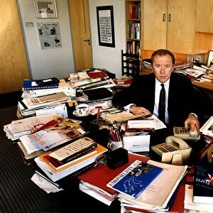David Frost TV Presenter a glance at his cluttered desk research material