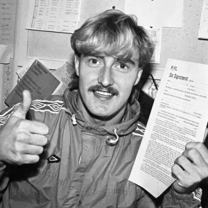 David Hodgson holding up a contract, giving a thumbs up sign, circa 1980s David Hodgson holding up a contract, giving a thumbs up sign, circa 1980s