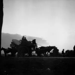 Dawn breaks on the Antwerp road revealing a line of refugees making for the city ahead of