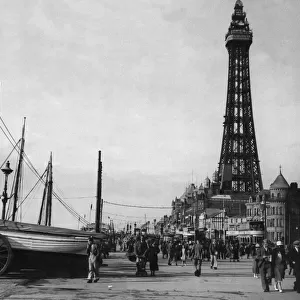 Day trippers enjoying the sea air with a walk along Blackpool