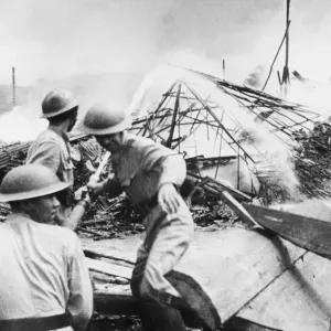 Last Days at Singapore. Civil defence workers fight the flames