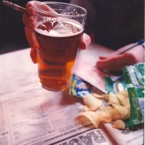 Four deadly sins smoking, drinking pints of beer and gambling with a bit of junk food