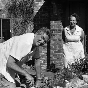 Denis Healey at work on a fishpond in his garden at his home in the Sussex countryside