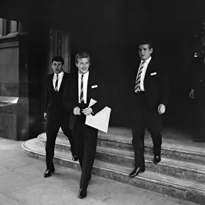 Denis Law leaves the Midland Hotel, Manchester, accompanied by Gerry and Joe Baker