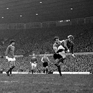 Denis Law of Manchester United beats a Sheffield Wednesday defender to fire a shot in
