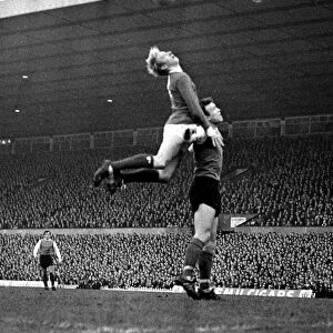 Denis Law of Manchester United jumps up for the ball during the league match against