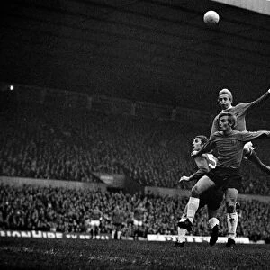 Denis Law of Manchester United jumps up for a high ball with Ipswich Town defenders