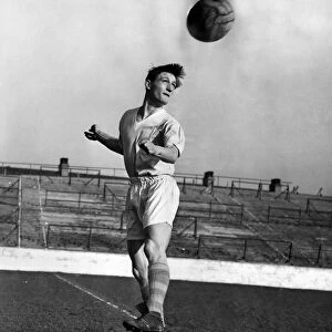 Dennis Fidler, the Manchester City outside left heading the ball during a training