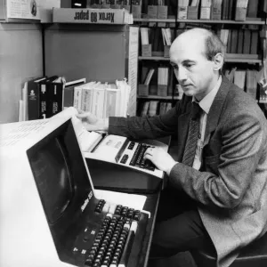 El bibliotecario adjunto de negocios y técnico Noel Hanson demuestra el ordenador en línea.