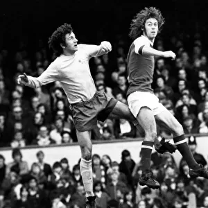 Derby Countys Roy McFarland leaps with Arsenal