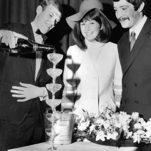 Derek Bower, wine waiter at the Moulin Rouge pours six champagne glasses at once
