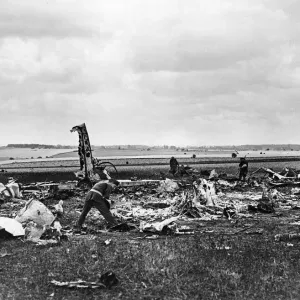 A destroyed Heinkel III bomber of the German Luftwaffe lies in a clover field in a small