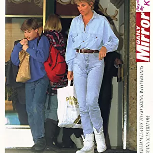 Diana, Princess of Wales carries a bag for her son Prince William as he leaves