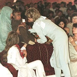 Diana, Princess of Wales cradles a sick child during a visit to the Shaukat Khanum
