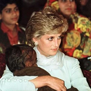Diana, Princess of Wales cuddles a blind child during a visit to the Shaukat Khanum