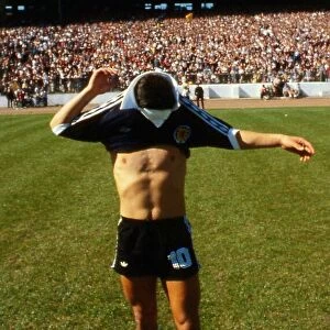Diego Maradona pulling on Scotland top 1979