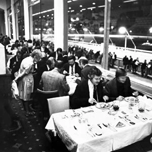 Diners enjoying their meal at Belle Vue Greyhound stadium while punters line trails