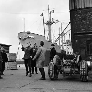 Its dinner break at the docks and these dockers get the ball out for a kick about in