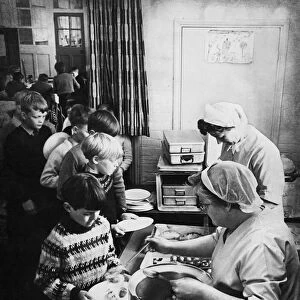 Dinner ladies dishing out school meals in the city of Cambridge. Circa 1967
