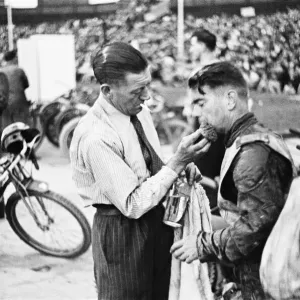 Dirt Track races in London. (Picture shows) A competitor receiving treatment for an Dirt Track races in London. (Picture shows) A competitor receiving treatment for an