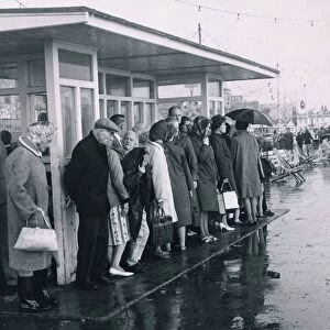 Disappointed holidaymakers shelter from the rain at Southend during the August Bank
