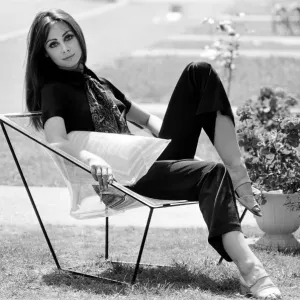 A display of modern furniture, a woman sitting on a transparent chair. 30th June 1969