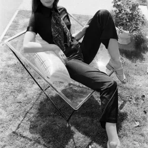 A display of modern furniture, a woman sitting on a transparent chair. 30th June 1969