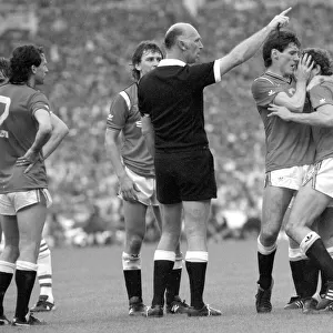 Distraught Manchester United footballer Kevin Moran is consoled by teammate Frank