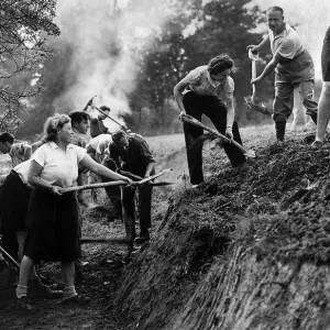 A Ditching'party of Women of the Volunteer Land Corps at work digging a deep A Ditching'party of Women of the Volunteer Land Corps at work digging a deep