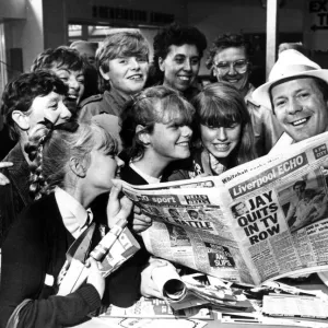 DJ Billy Butler shows off the new style of tabloid Liverpool Echo to visitors to the Echo