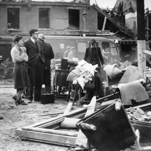 Doctor Waters, wearing glasses, watches rescue work in progress after a V2 Bomb fell Doctor Waters, wearing glasses, watches rescue work in progress after a V2 Bomb fell