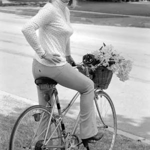 Doris Day seen holding a bunch of flowers on her bicyle Doris Day seen holding a bunch of flowers on her bicyle