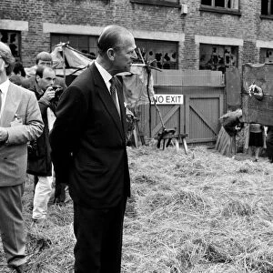 The Duke of Edinburgh visits a film set, chatting to an actor in a pillory - 17 / 7 / 1987