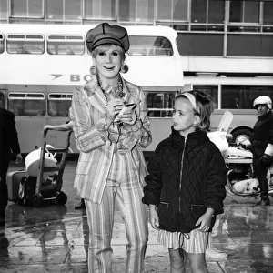 Dusty Springfield pictured at London Heathrow airport signing an autograph for a young
