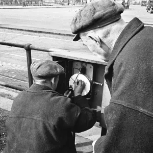 Edward Farmer and assistant seen here checking a sewage flow meter on the embankment Edward Farmer and assistant seen here checking a sewage flow meter on the embankment